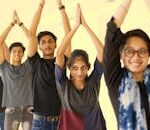 A vibrant group of young adults in a yoga class exuding enthusiasm and concentration.