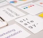 A top view of marketing strategy documents and graphs arranged on a desk, showcasing business planning.