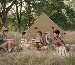 A group of children camping in the wilderness, enjoying outdoor activities and nature exploration.